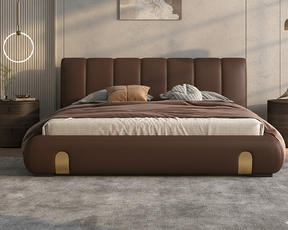 Brown leather bed with gold accents in a modern bedroom setting