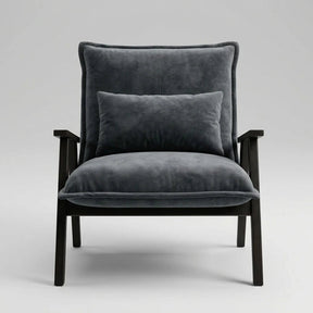 A modern armchair with dark gray velvet upholstery and a matching back cushion, supported by a dark wood frame, shown against a neutral light gray background.