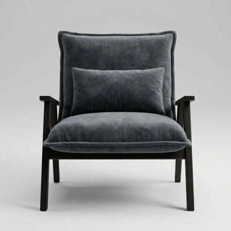 A modern armchair with dark gray velvet upholstery and a matching back cushion, supported by a dark wood frame, shown against a neutral light gray background.