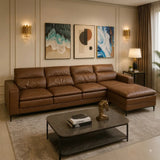 A modern brown leather sectional sofa with a chaise lounge, styled in a contemporary living room with abstract wall art, gold sconces, a marble coffee table, and a gray rug.
