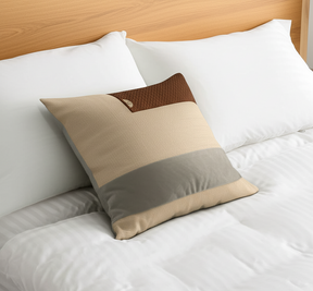 Decorative pillow with brown and beige pattern on a bed