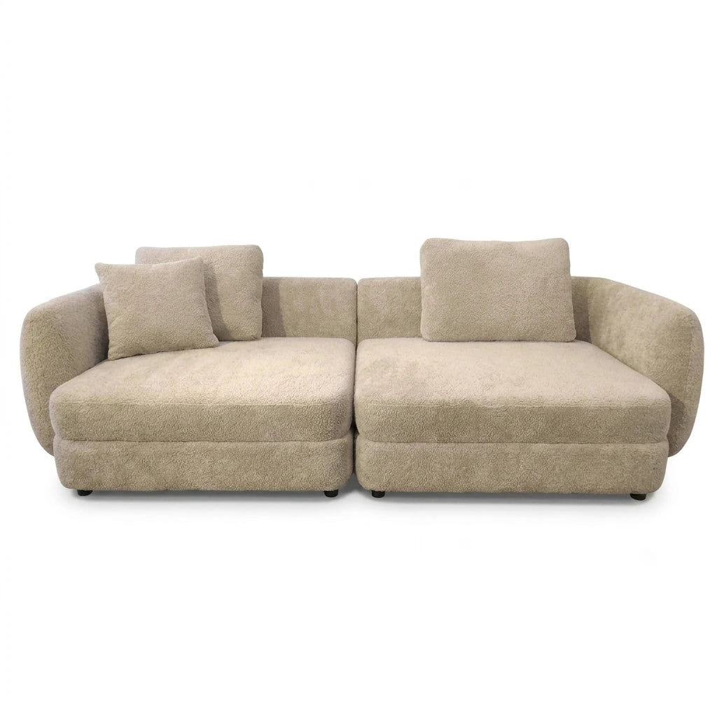 A modern two-seater sofa upholstered in a textured beige bouclé fabric, featuring two matching square throw pillows, shown against a plain white background.